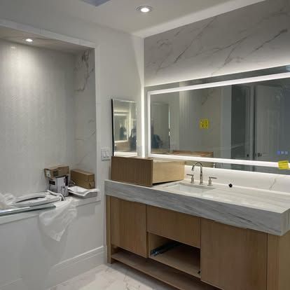 Backlit LED vanity mirror installed during a bathroom remodel in Palm Coast Plantation