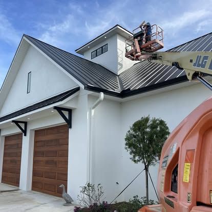 Working from a cherry-picker lift changing accent and recessed lighting at a waterfront estate, Flagler Beach