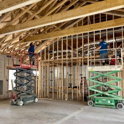 Mike and Brian on a lift wiring the great room of a 9,000 square foot custom home in Ormond
