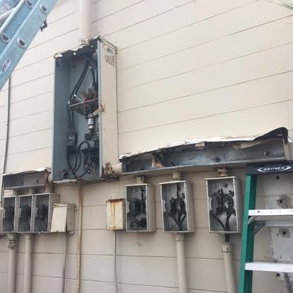 Before: aging commercial meter bank on the Flagler Pharmacy building, Flagler Beach