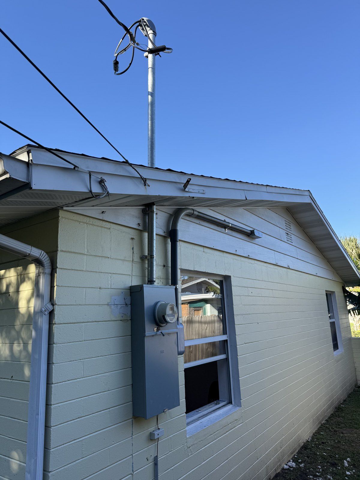 After: new 200A meter main combo with riser, weatherhead and ground rods — Ormond-by-the-Sea