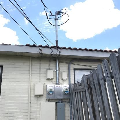 New service mast and twin meters on a Spanish tile roof home behind Pirates Cove, Ormond Beach