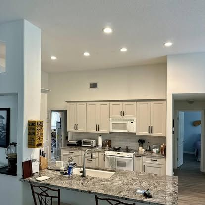 White kitchen remodel with recessed lighting in Plantation Bay, Ormond Beach